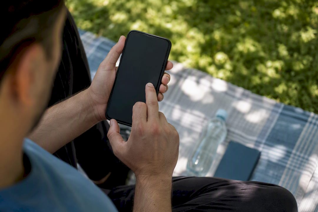 Hands performing crypto transfer on phone