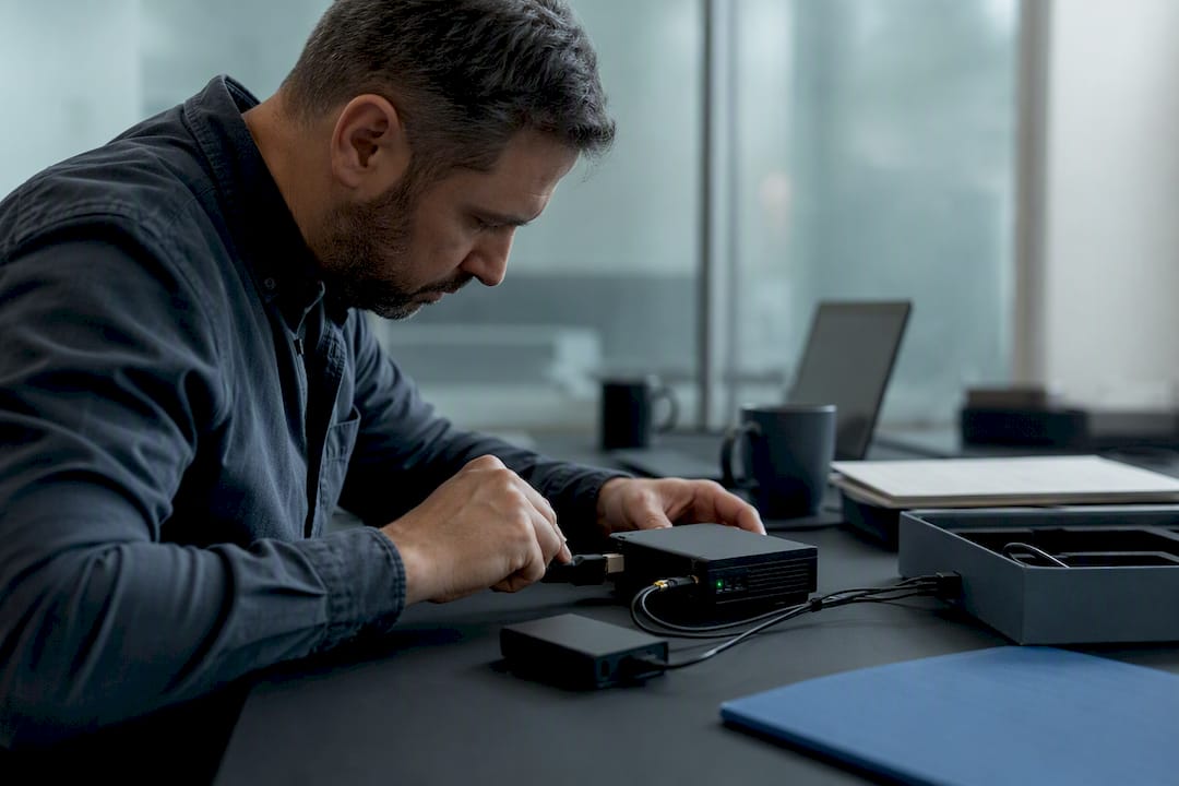Hands connecting forensic blockchain hardware device