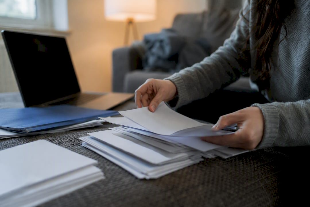 Hands organizing crypto transaction records
