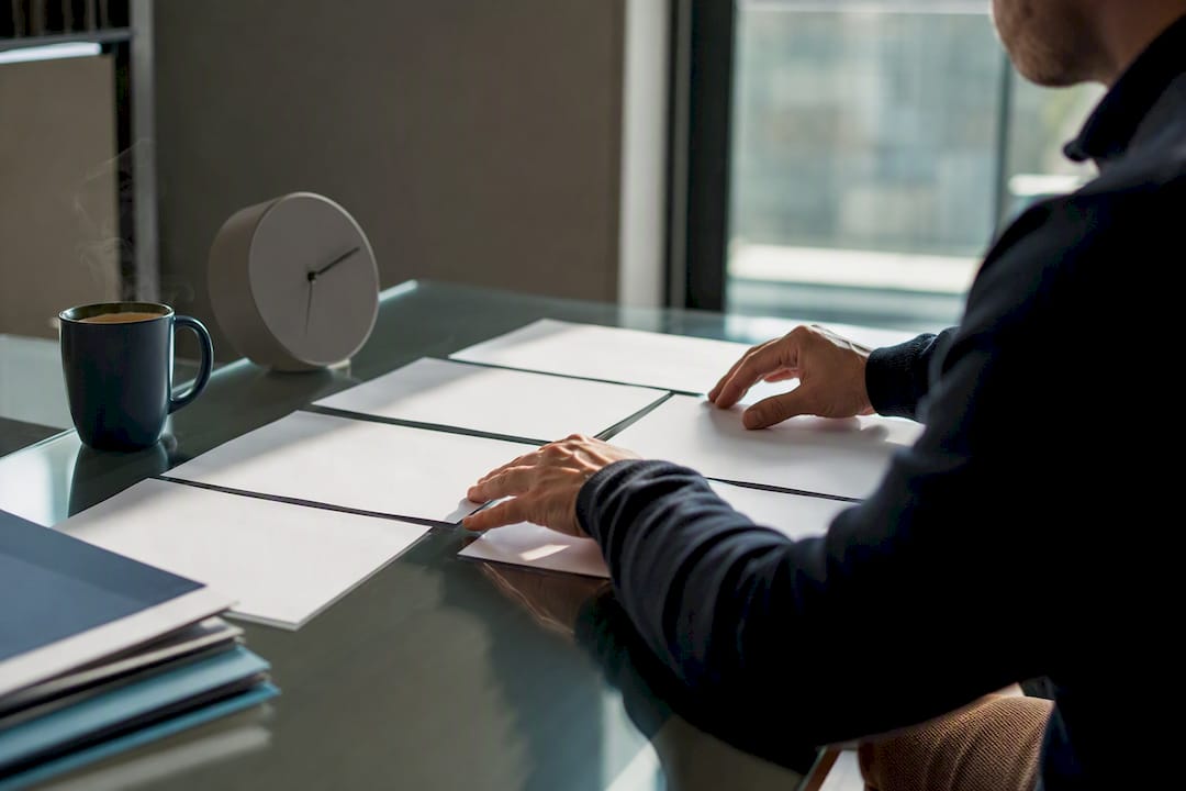 Hands arranging blockchain forensic report papers