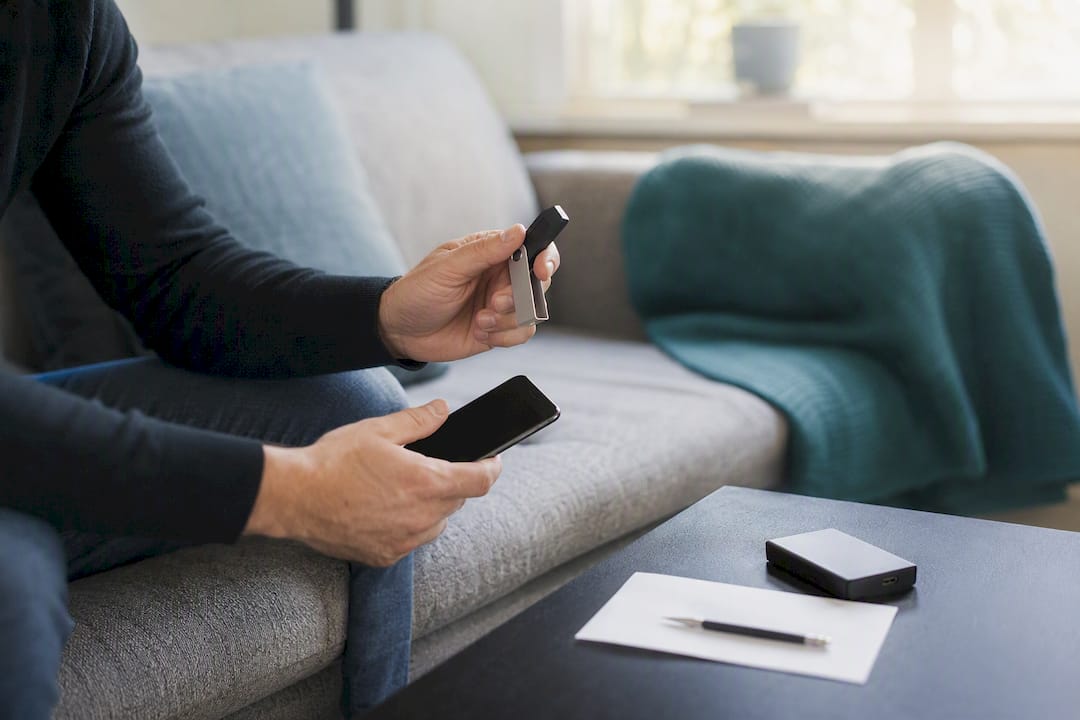 Hands preserving cryptocurrency evidence with hardware wallet